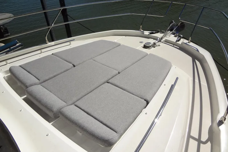 Slide: The Image of 2023 Prestige 420S yacht cruising on a serene lake with scenic hills. - 3