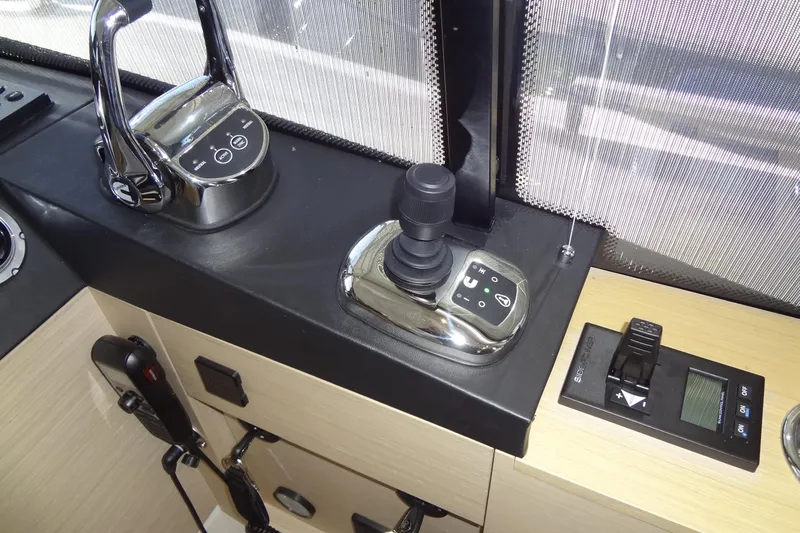 Slide: The Image of 2023 Prestige 420S yacht interior with beige leather seating and modern helm station. - 42