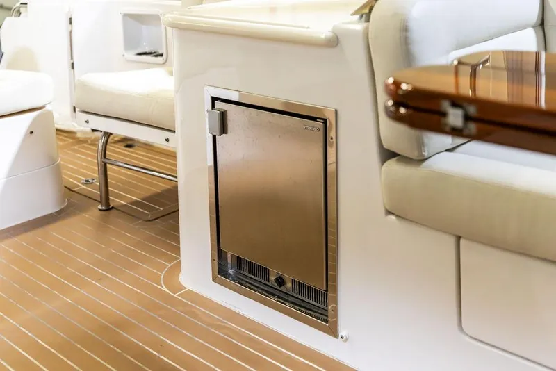 Slide: The Image of 2018 MJM 35z yacht interior with seating and built-in refrigerator. - 10