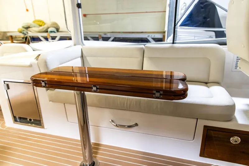 Slide: The Image of Interior of 2018 MJM 35z boat with wooden table and white seating. - 12
