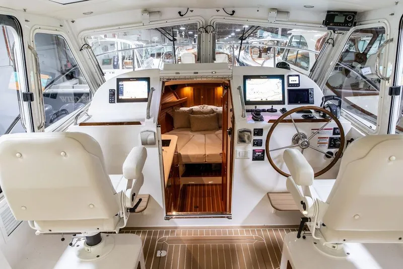 Slide: The Image of Interior of 2018 MJM 35z boat with helm, navigation screens, and cabin view. - 13