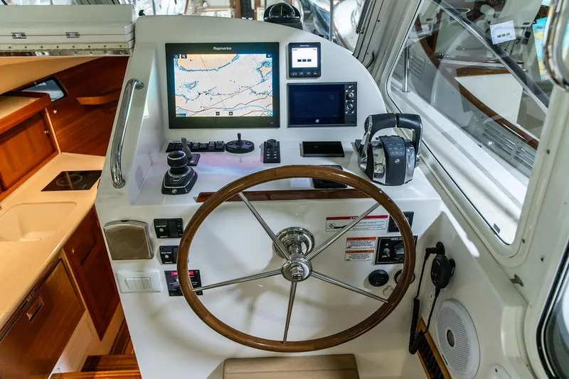 Slide: The Image of Helm of 2018 MJM 35z boat with navigation equipment and wooden steering wheel. - 14