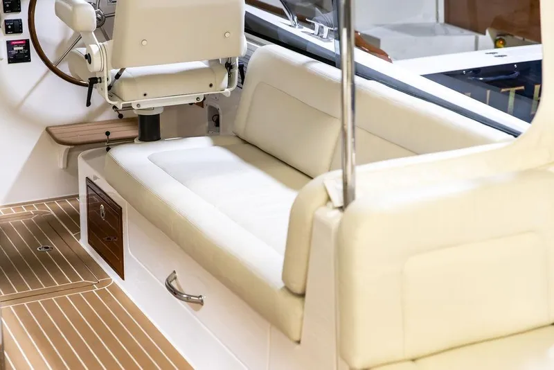 Slide: The Image of 2018 MJM 35z boat interior with cream seating and wooden flooring. - 19