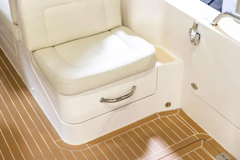 Slide: The Image of 2018 MJM 35z boat interior with cushioned seating and teak-style flooring. - 20