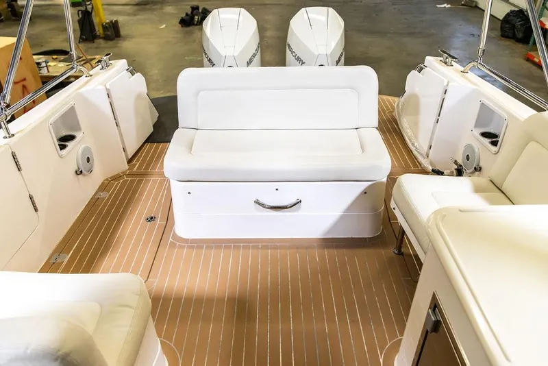 Slide: The Image of 2018 MJM 35z boat interior with white seating and twin outboard engines. - 22