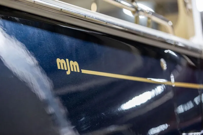 Slide: The Image of Close-up of 2018 MJM 35z boat with logo on sleek blue hull. - 32