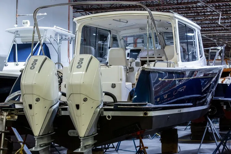 Slide: The Image of 2018 MJM 35z boat with dual 300 horsepower engines in a showroom. - 4