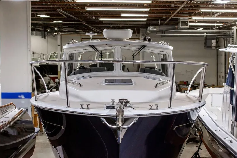 Slide: The Image of 2018 MJM 35z boat in indoor storage, front view with sleek design and polished finish. - 6