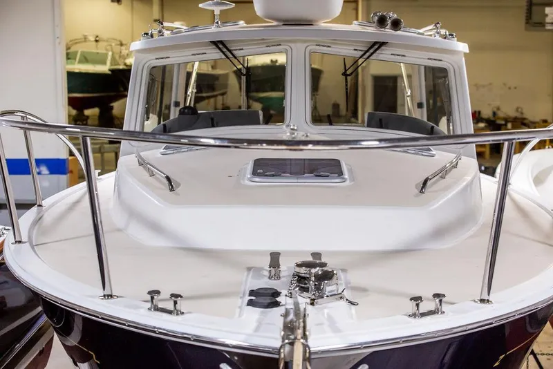 Slide: The Image of 2018 MJM 35z boat in a showroom, showcasing sleek design and polished railings. - 7