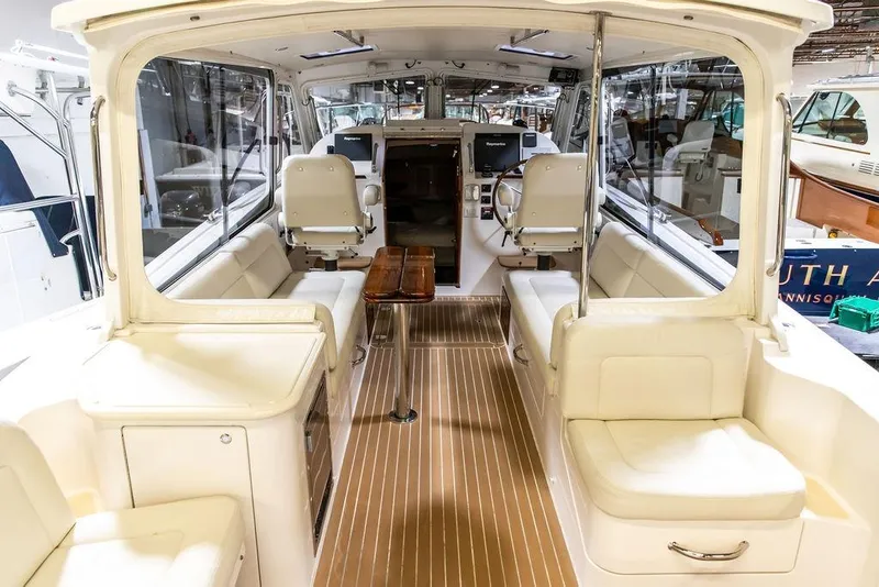 Slide: The Image of 2018 MJM 35z boat interior with seating, wooden table, and helm station. - 9