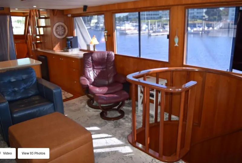 Slide: The Image of Luxurious 2002 Grand Alaskan Cockpit Motor Yacht interior with leather seating and wooden finishes. - 16