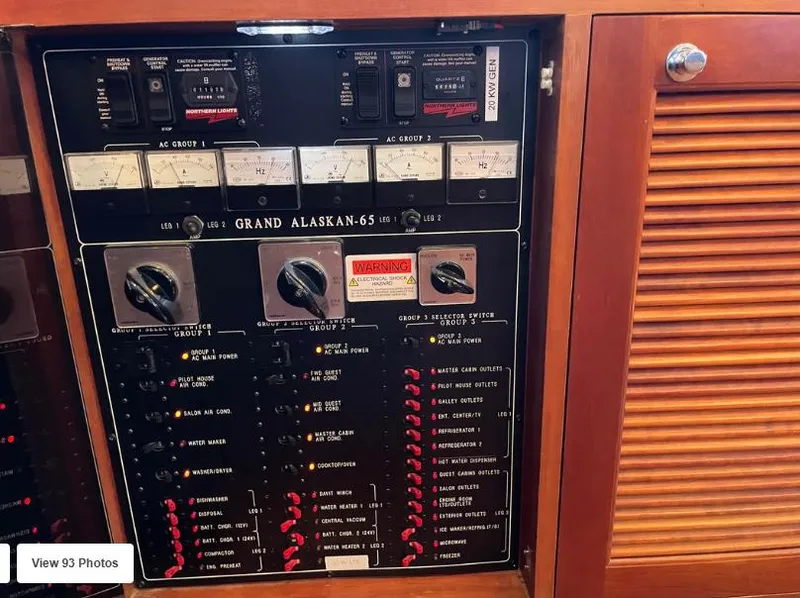 Slide: The Image of Electrical panel of a 2002 Grand Alaskan Cockpit Motor Yacht with various switches and controls. - 21