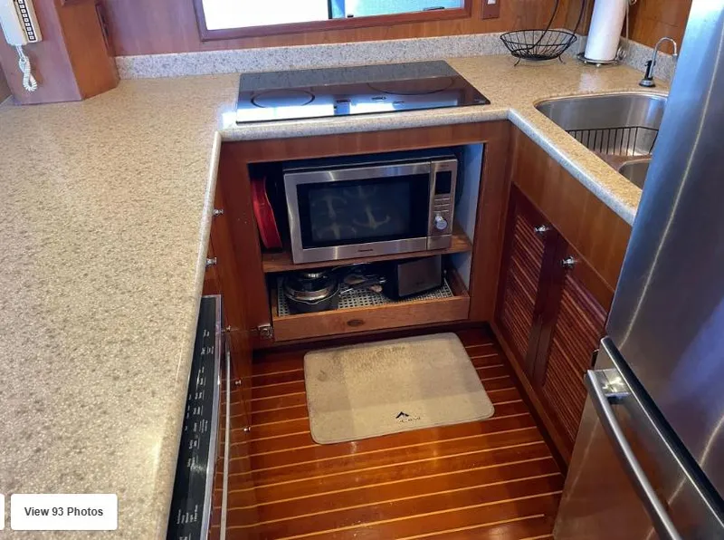 Slide: The Image of Kitchen area of 2002 Grand Alaskan Cockpit Motor Yacht with microwave and modern appliances. - 27