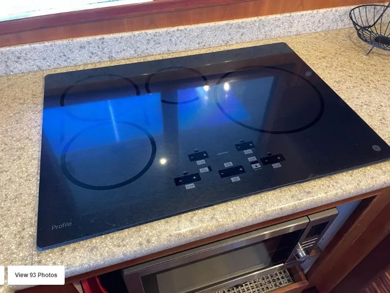 Slide: The Image of Modern electric cooktop on a 2002 Grand Alaskan Cockpit Motor Yacht kitchen counter. - 28