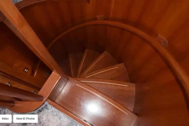 Slide: The Image of Wooden spiral staircase inside 2002 Grand Alaskan Cockpit Motor Yacht. - 30