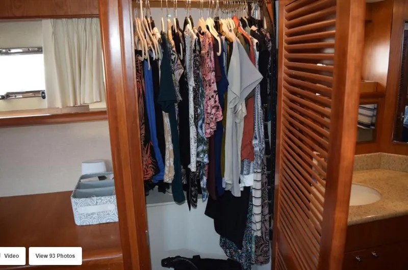 Slide: The Image of Closet with clothes in 2002 Grand Alaskan Cockpit Motor Yacht interior. - 35