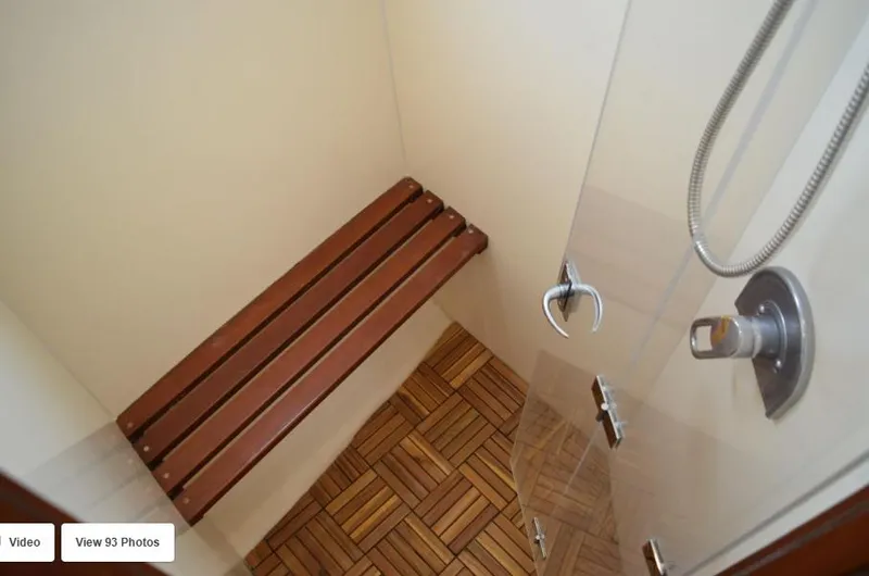 Slide: The Image of Shower area with wooden bench in 2002 Grand Alaskan Cockpit Motor Yacht. - 44