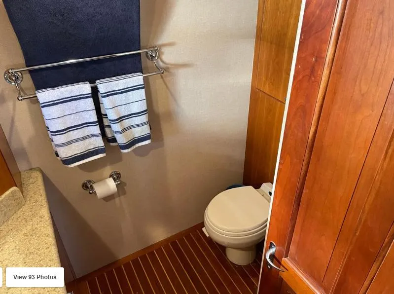 Slide: The Image of 2002 Grand Alaskan Cockpit Motor Yacht bathroom with wooden flooring and towel rack. - 49