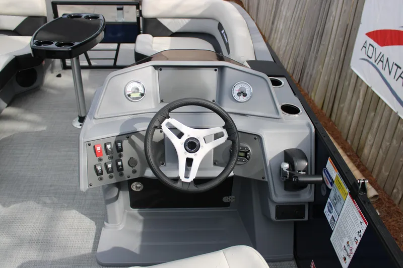 Slide: The Image of Steering console of 2026 Starcraft VX 24 Q DH boat with modern controls and seating. - 10