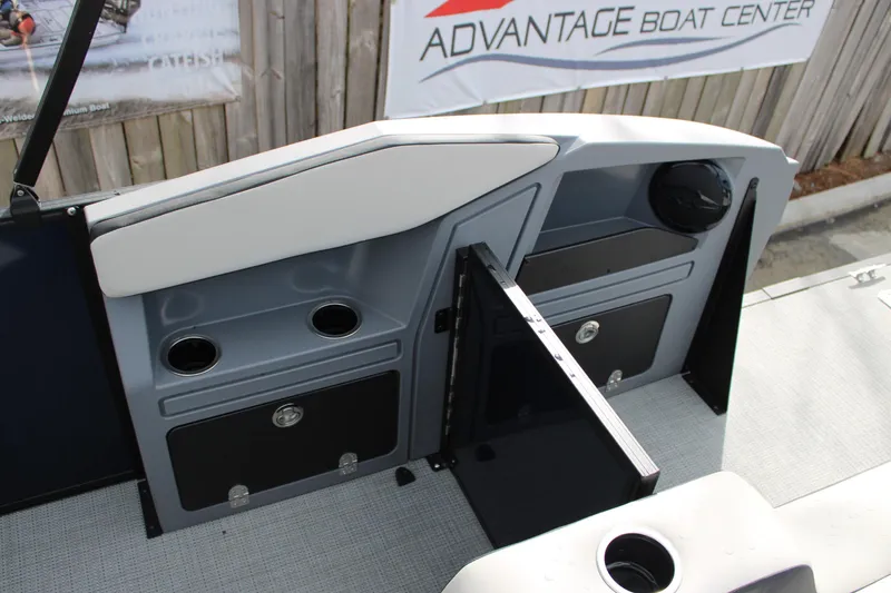 Slide: The Image of Interior of 2026 Starcraft VX 24 Q DH boat with storage compartments and cup holders. - 12