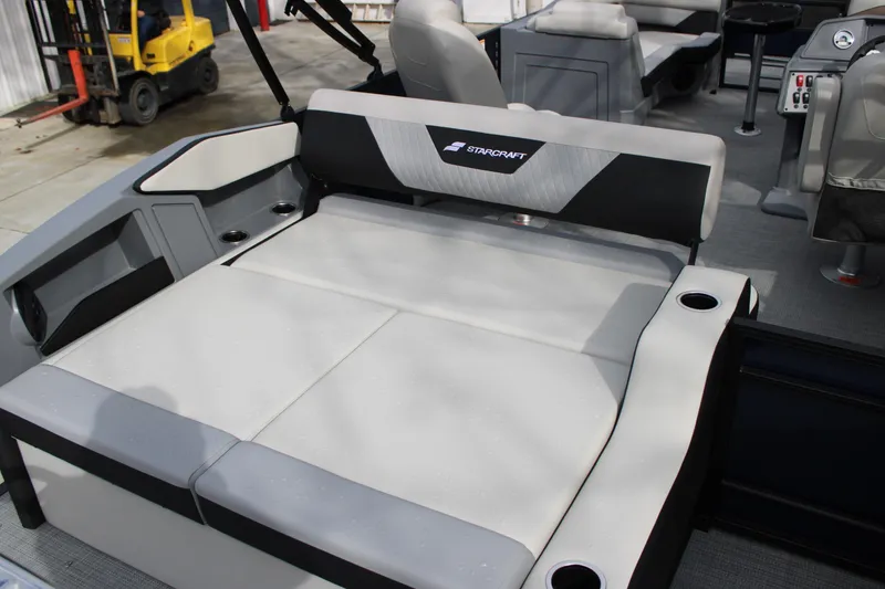 Slide: The Image of 2026 Starcraft VX 24 Q DH boat interior with cushioned seating and cup holders. - 13
