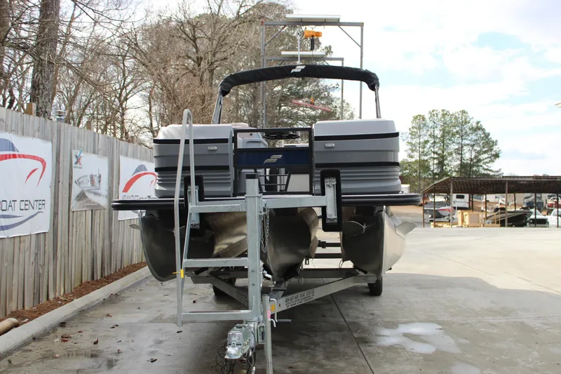 Slide: The Image of 2026 Starcraft VX 24 Q DH pontoon boat on trailer at a boat center. - 3