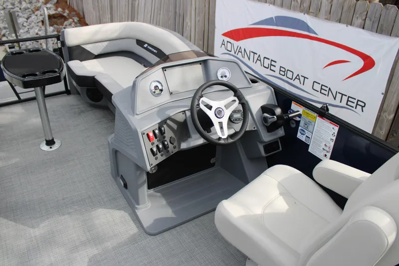 Slide: The Image of 2026 Starcraft VX 24 Q DH boat interior with steering console and seating. - 8