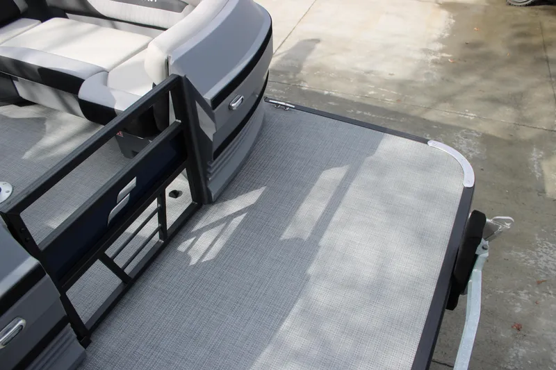 Slide: The Image of 2026 Starcraft VX 24 Q DH boat deck with seating and open gate. - 9