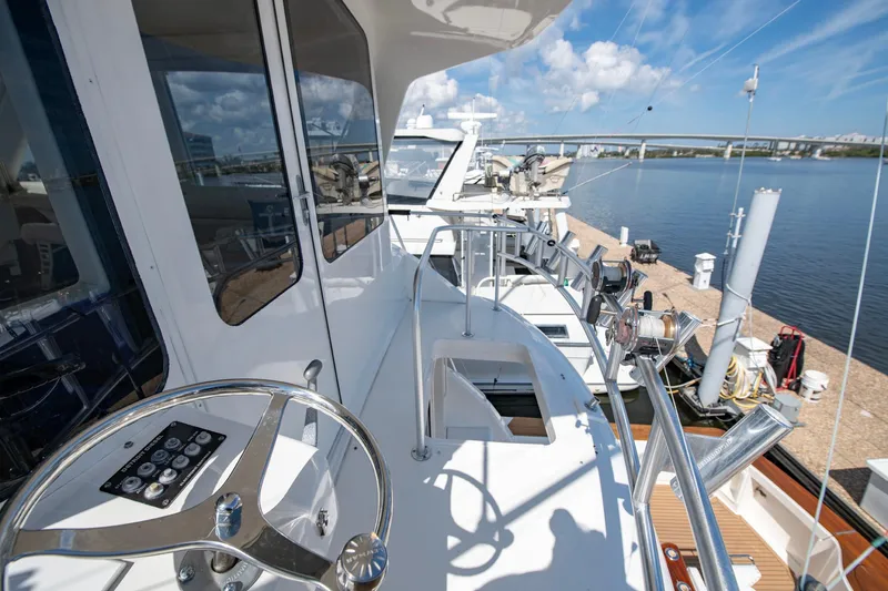 Slide: The Image of 2003 Ocean Yachts 62 Super Sport EB yacht docked, featuring sleek design and modern controls. - 12