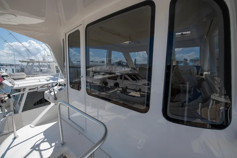 Slide: The Image of 2003 Ocean Yachts 62 Super Sport EB, exterior view with reflections on windows. - 14