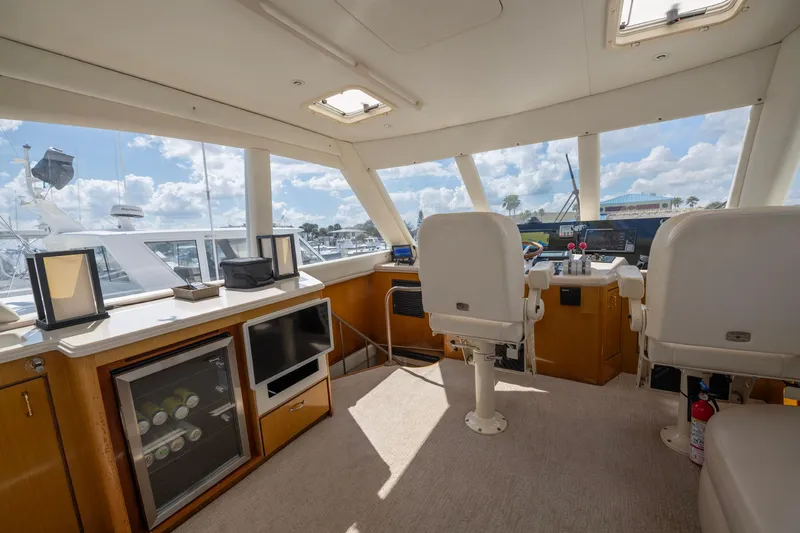 Slide: The Image of Interior of 2003 Ocean Yachts 62 Super Sport EB, featuring helm and seating area. - 19