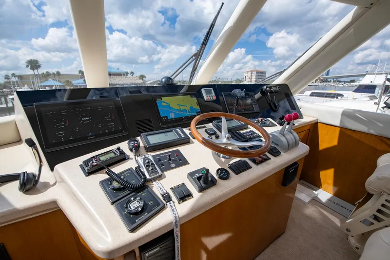 Slide: The Image of Cockpit of 2003 Ocean Yachts 62 Super Sport EB with navigation equipment and wooden steering wheel. - 24