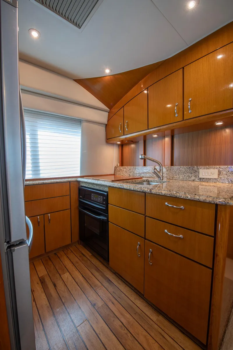 Slide: The Image of Luxurious kitchen in 2003 Ocean Yachts 62 Super Sport EB with wood cabinetry and granite countertops. - 34