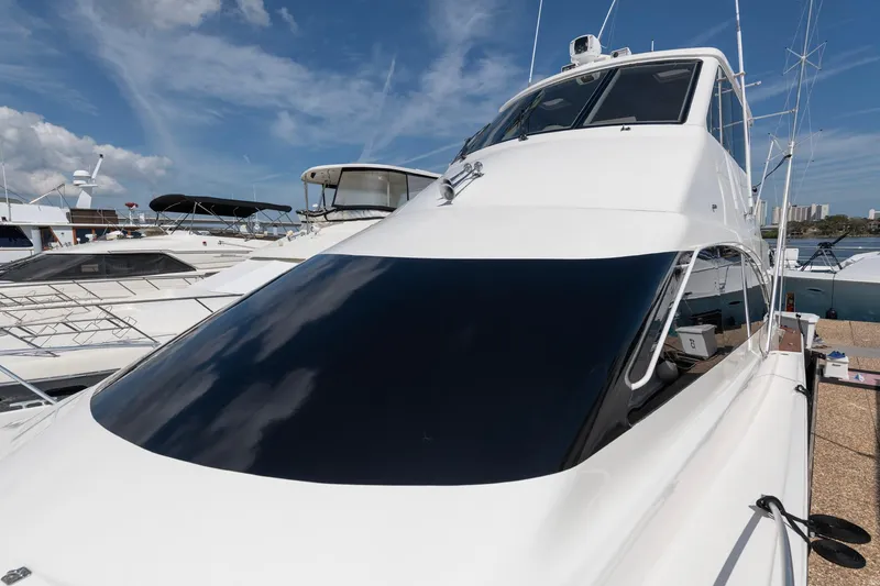 Slide: The Image of 2003 Ocean Yachts 62 Super Sport EB, sleek design, docked under clear blue sky. - 4