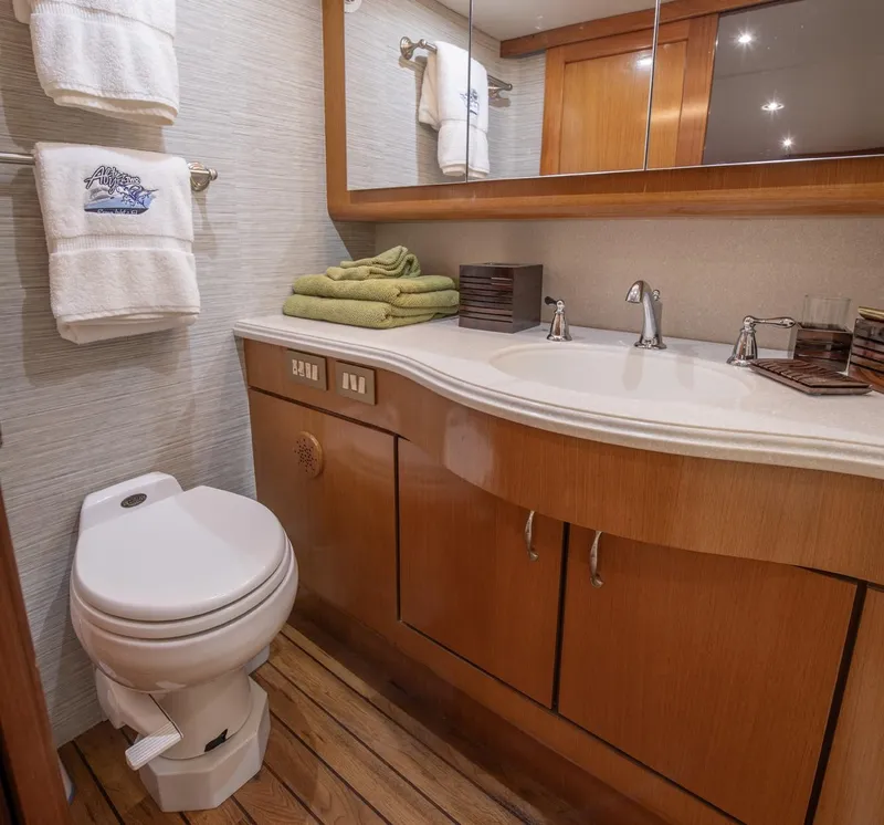 Slide: The Image of Luxurious bathroom in 2003 Ocean Yachts 62 Super Sport EB with wooden cabinetry and modern fixtures. - 44