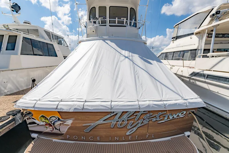 Slide: The Image of 2003 Ocean Yachts 62 Super Sport EB docked, covered, with custom name and graphics. - 6