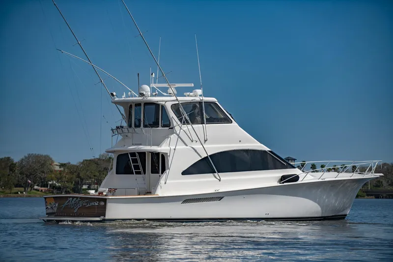 Slide: The Image of 2003 Ocean Yachts 62 Super Sport EB cruising on calm waters under clear blue skies. - 1