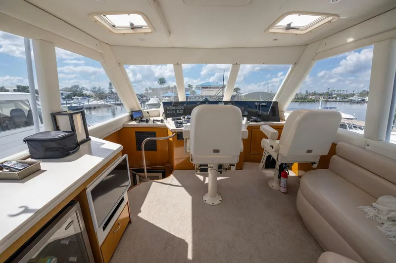 Slide: The Image of Interior of 2003 Ocean Yachts 62 Super Sport EB, featuring helm and seating area. - 18