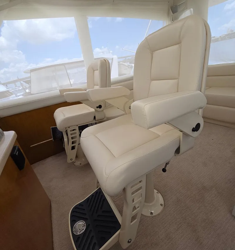 Slide: The Image of 2003 Ocean Yachts 62 Super Sport EB interior with plush captain's chairs and panoramic windows. - 21
