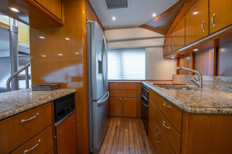 Slide: The Image of Luxurious kitchen interior of 2003 Ocean Yachts 62 Super Sport EB with wood cabinetry. - 33