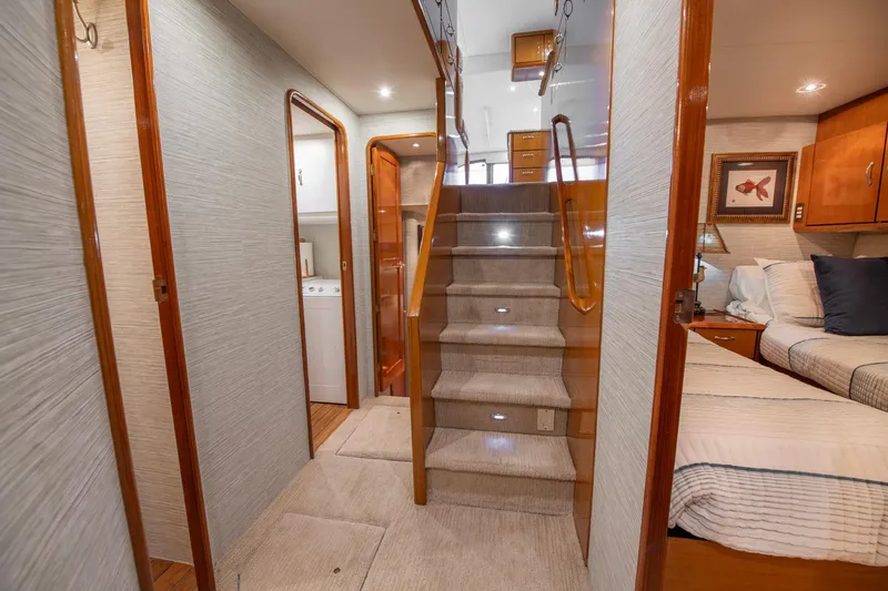 Slide: The Image of Interior of 2003 Ocean Yachts 62 Super Sport EB, featuring stairs and cozy bedroom. - 36