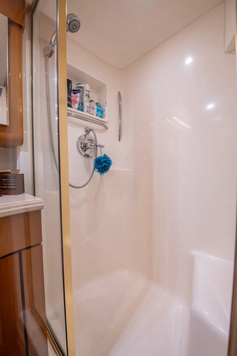 Slide: The Image of Shower area in 2003 Ocean Yachts 62 Super Sport EB, featuring modern fixtures and storage. - 45