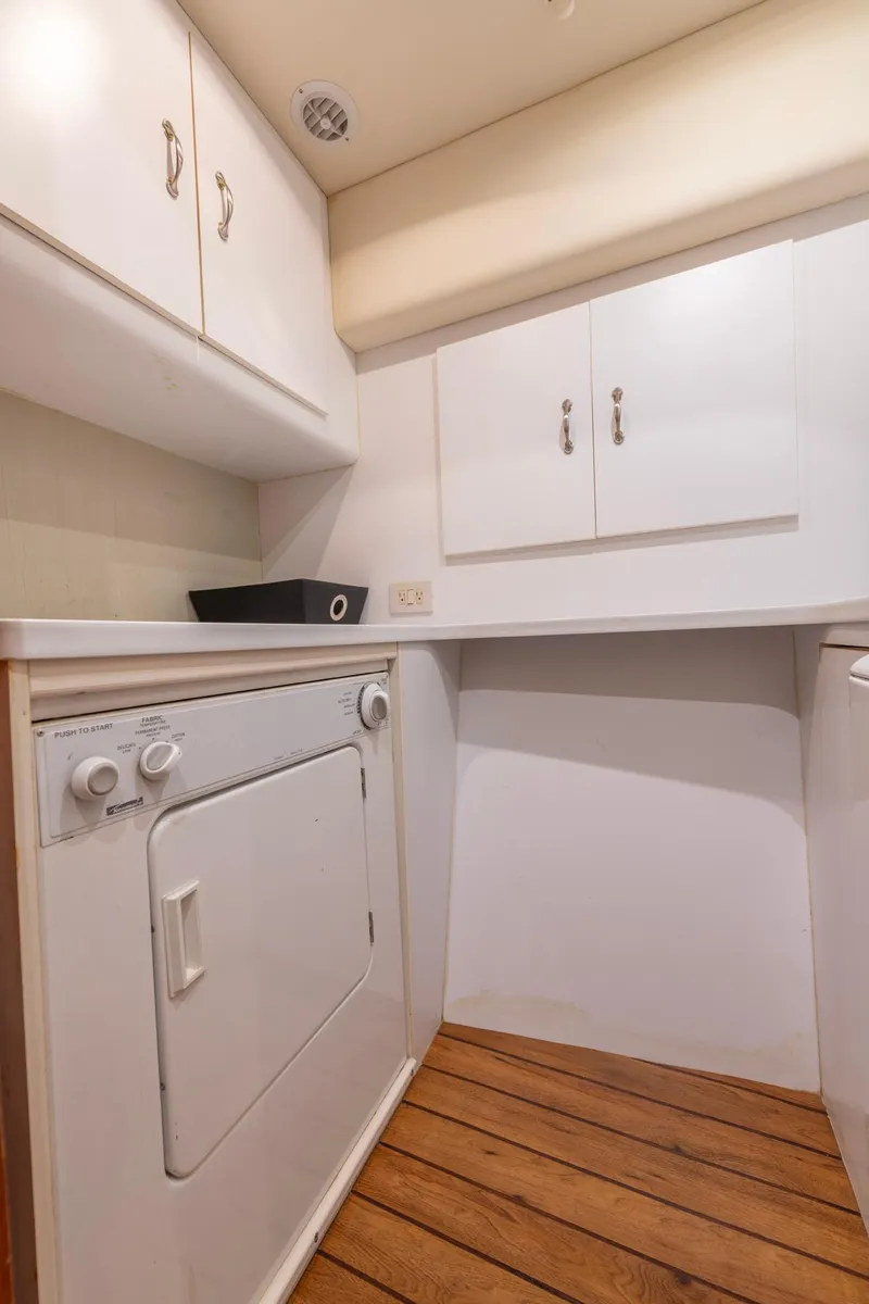 Slide: The Image of Laundry area in 2003 Ocean Yachts 62 Super Sport EB with wooden flooring. - 47