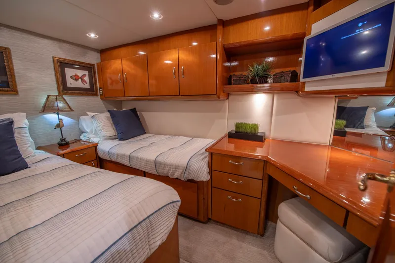 Slide: The Image of Luxurious cabin interior of 2003 Ocean Yachts 62 Super Sport EB with twin beds and wooden cabinetry. - 48