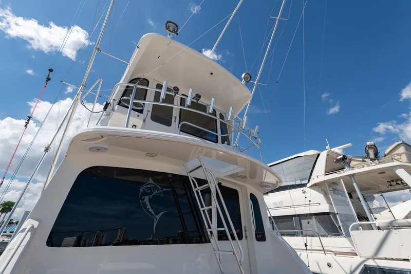 Slide: The Image of 2003 Ocean Yachts 62 Super Sport EB, docked under a clear blue sky. - 9
