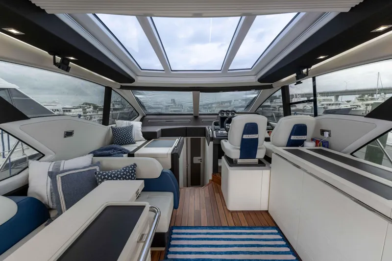Slide: The Image of Luxurious interior of a 2015 Azimut 55S yacht with modern seating and panoramic windows. - 17