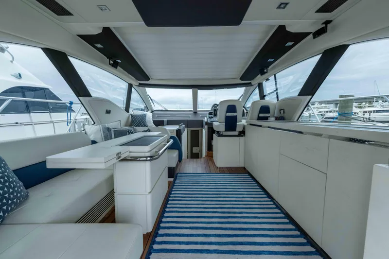 Slide: The Image of Luxurious interior of a 2015 Azimut 55S yacht with modern seating and striped rug. - 18