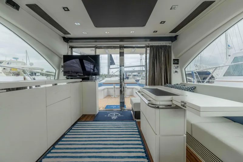 Slide: The Image of Luxurious interior of a 2015 Azimut 55S yacht with modern furnishings and marina view. - 19