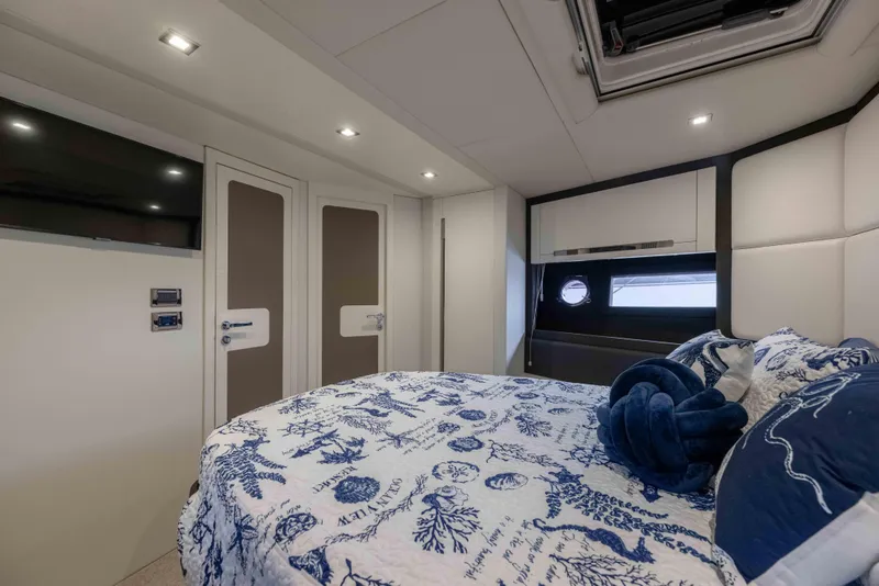 Slide: The Image of Luxurious bedroom interior of 2015 Azimut 55S yacht with nautical-themed bedding. - 22