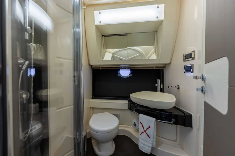 Slide: The Image of Luxurious bathroom in a 2015 Azimut 55S yacht, featuring modern fixtures and elegant design. - 26